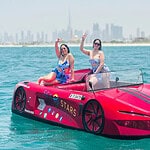 Luxury speedboat ride in Dubai water with women enjoying spectacular skyline views.